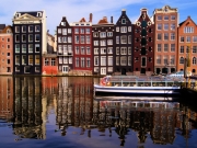 Traditional houses of Amsterdam with canal reflections